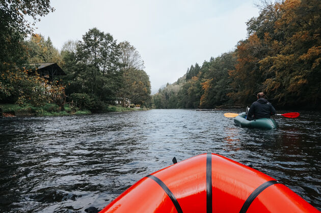 <em>Trek warme kleding aan en geniet van de rust tijdens het packraften over de rivier.<\/em>